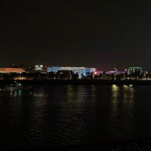 A peaceful image of Al Zeina Hidden Beach in Abu Dhabi, soft glow of Yas Island's lights.
