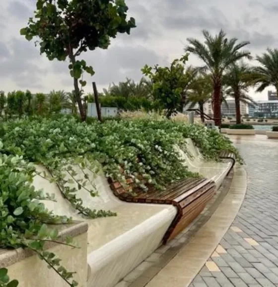 Walking track in Abu Dhabi Reem Central Park with greenery and benches