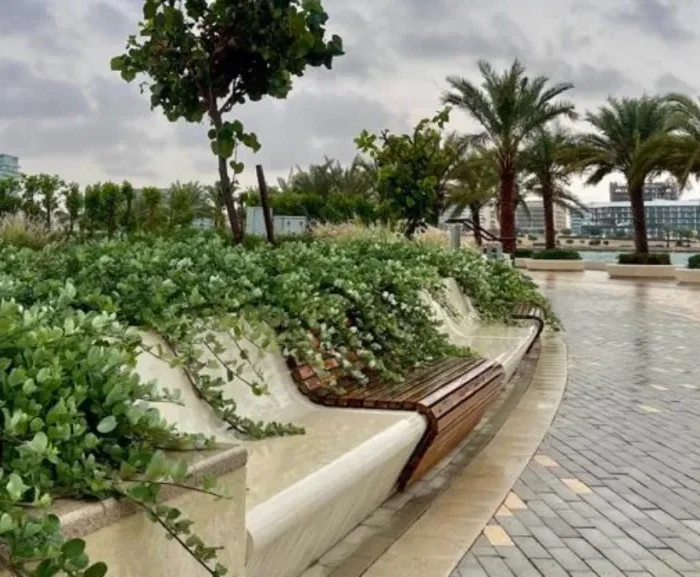 Walking track in Abu Dhabi Reem Central Park with greenery and benches