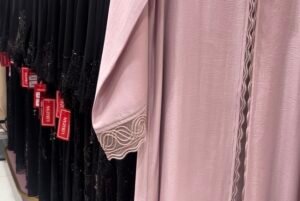 Close-up of Louzan abaya fabric and embroidery details inside Yas Mall store in Abu Dhabi.