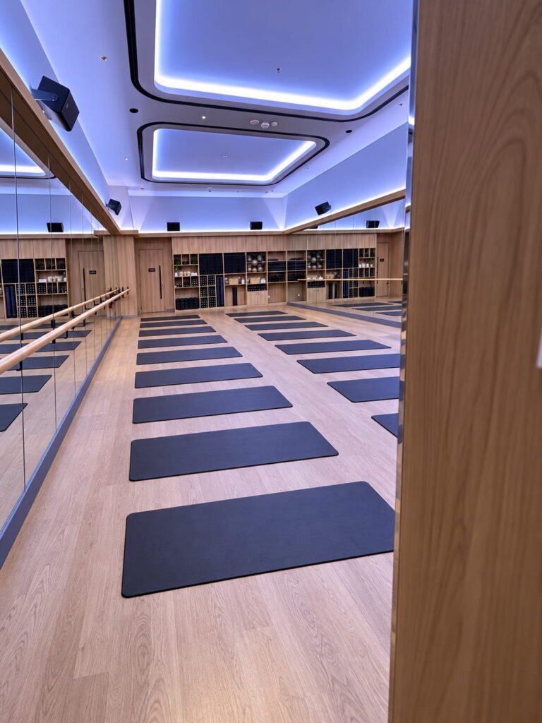 FitnGlam barre workout studio in Abu Dhabi featuring ballet barres, exercise mats, and mirrored walls.
